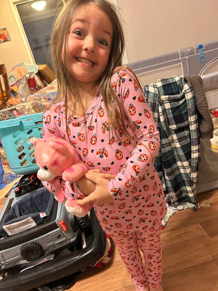 Customer photo: smiling girl in pink pajamas