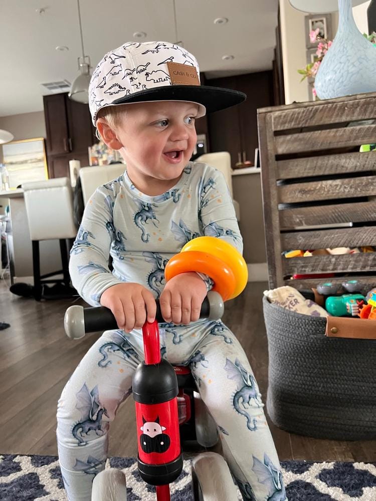 Customer photo: toddler on a ride-on toy in pajamas